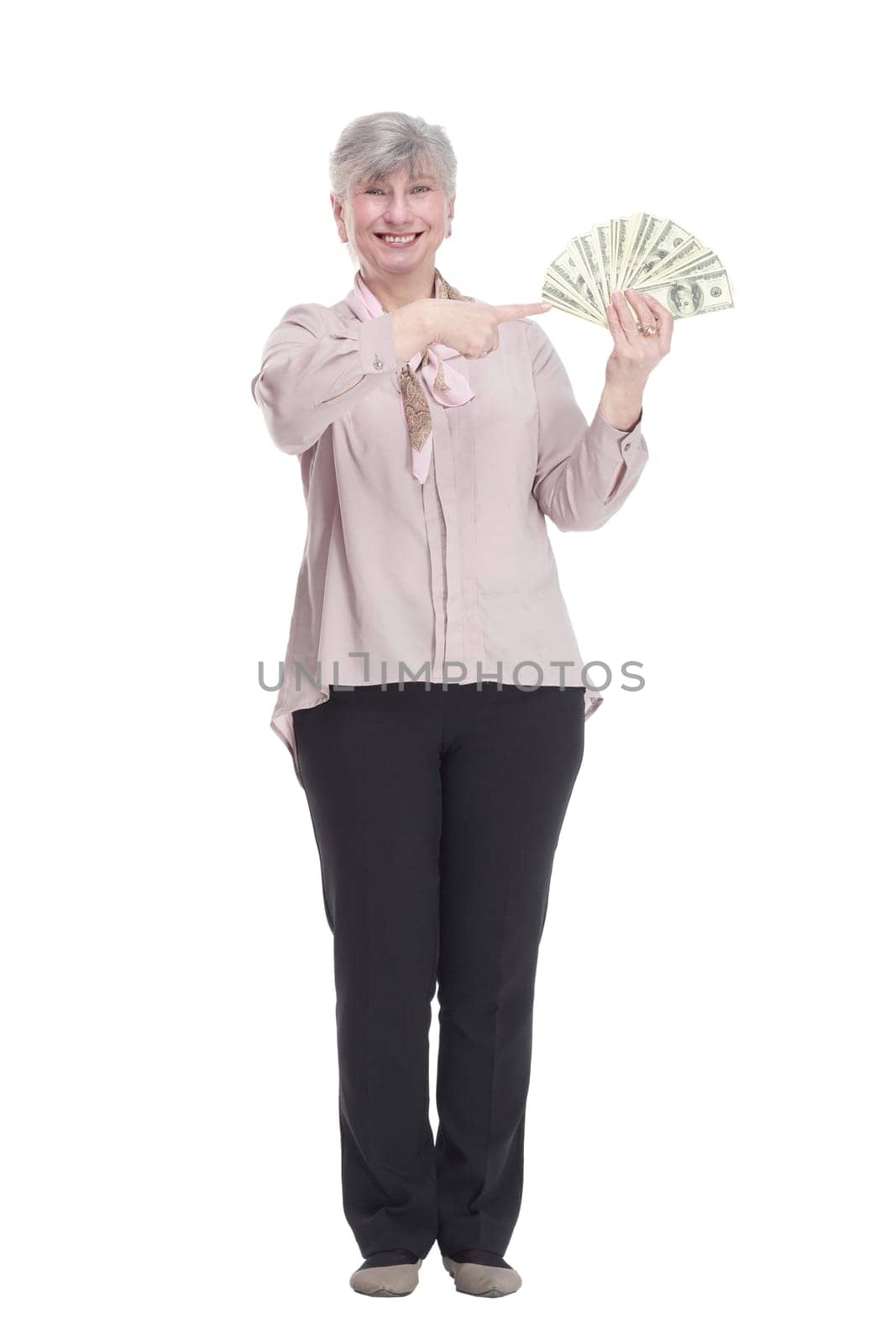 in full growth. friendly old woman with a fan of dollar bills . isolated on a white background.
