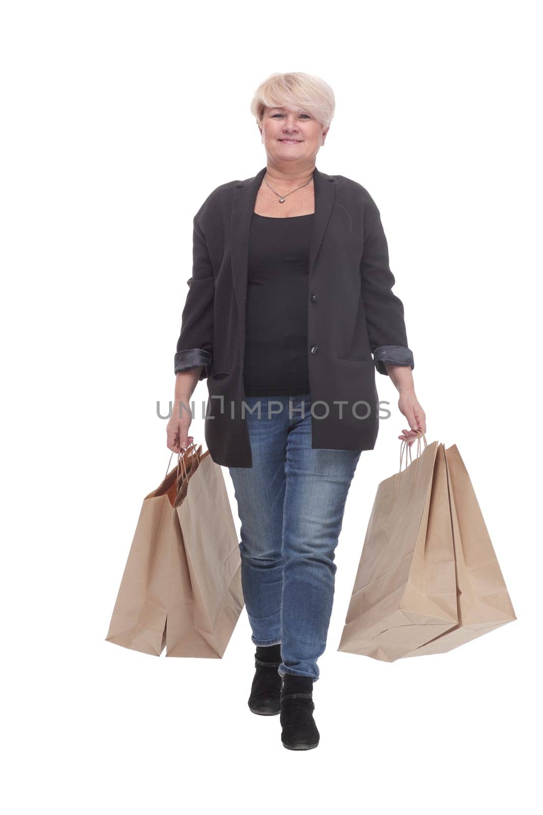 full-length. casual mature woman with shopping bags . isolated on a white background.