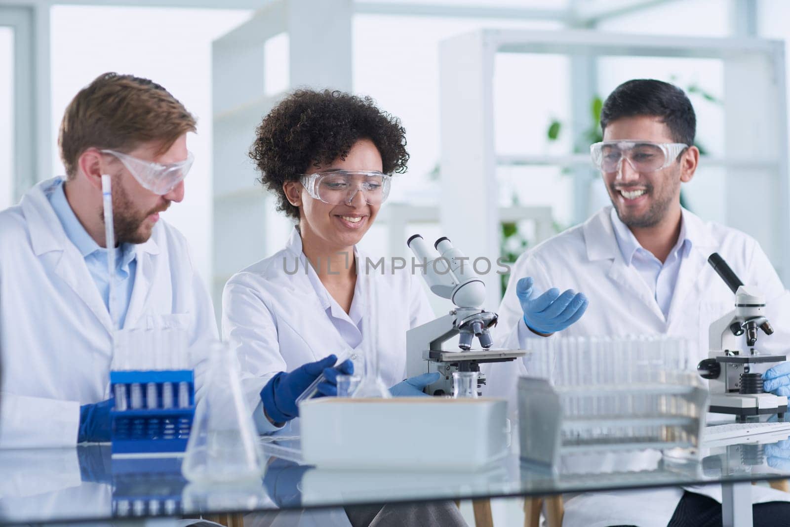 Team of Scientists Working Using Microscope, Analysing Microbiology Samples