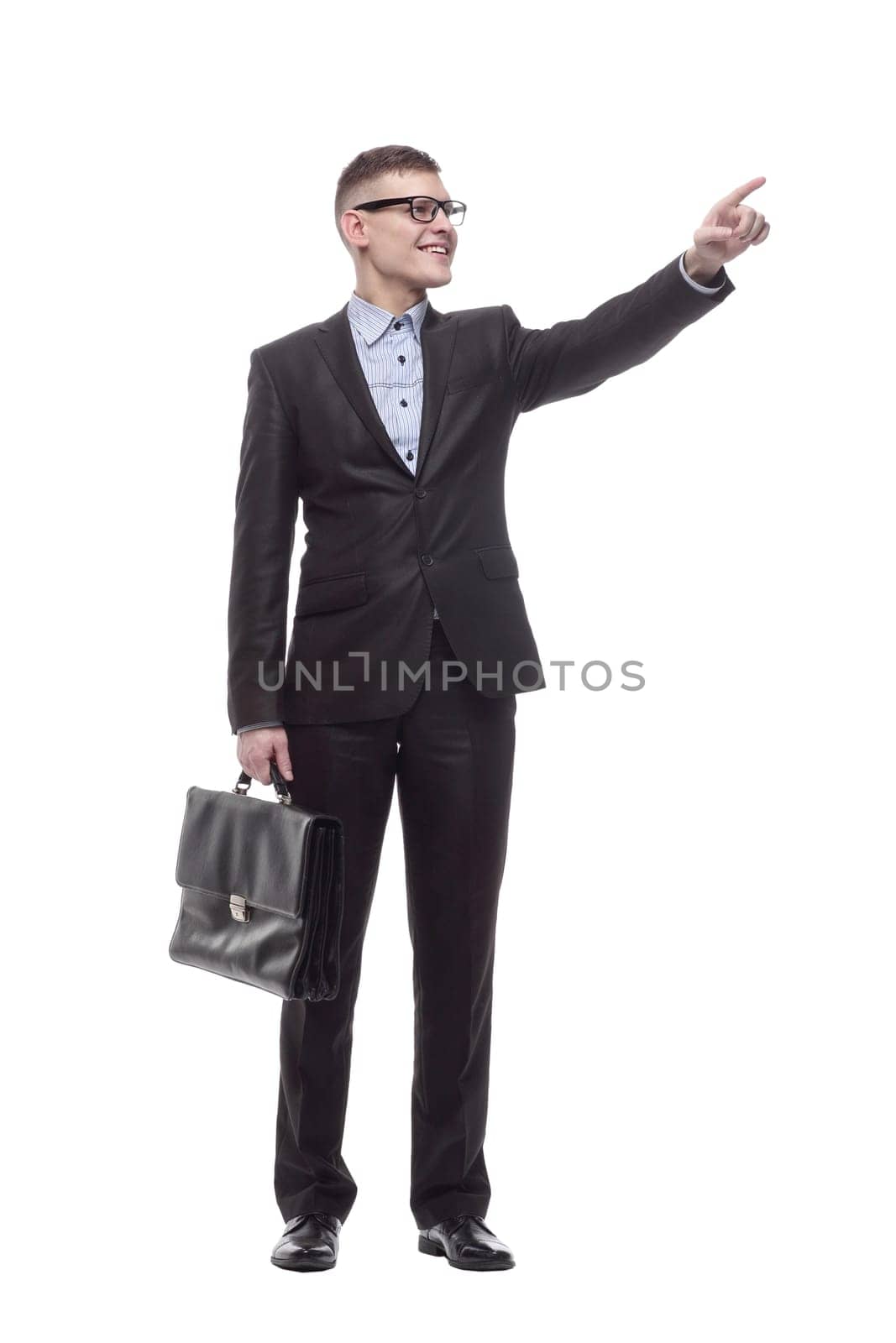 in full growth. smiling young businessman with a leather briefcase. isolated on a white background.