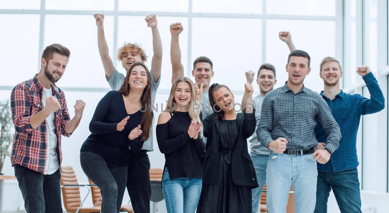 team of happy young people standing in a new office by asdf