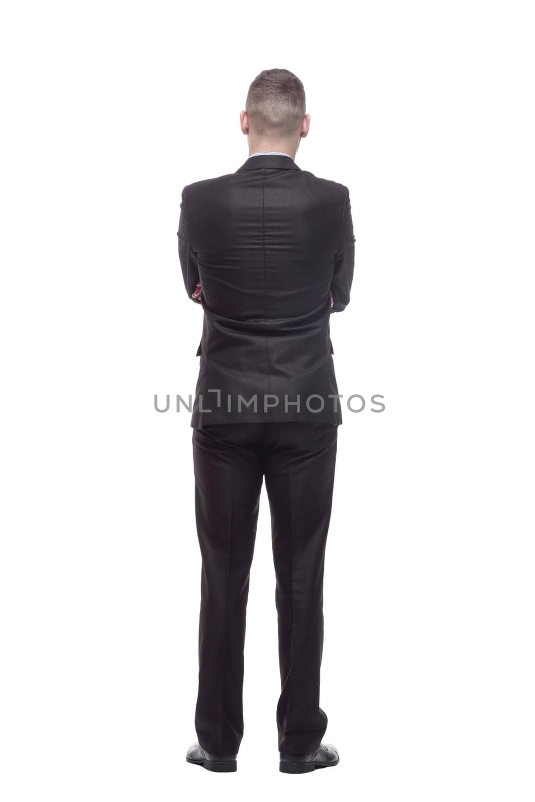 rear view. handsome young businessman. isolated on a white background.