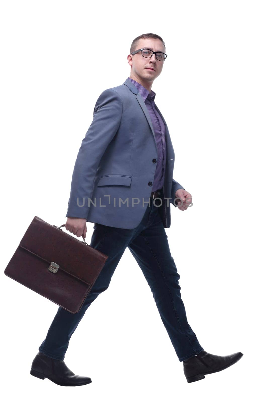 Side view business man holding brief case and walking over white background