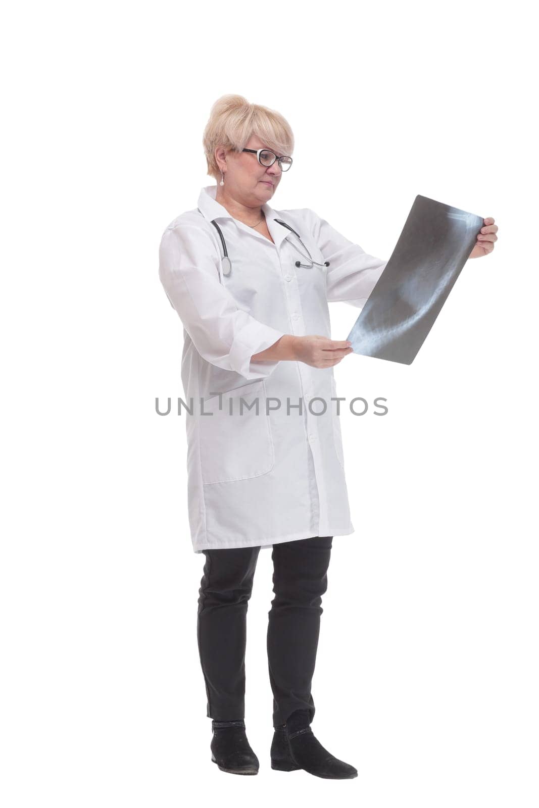in full growth. competent doctor with an x-ray. isolated on a white background.