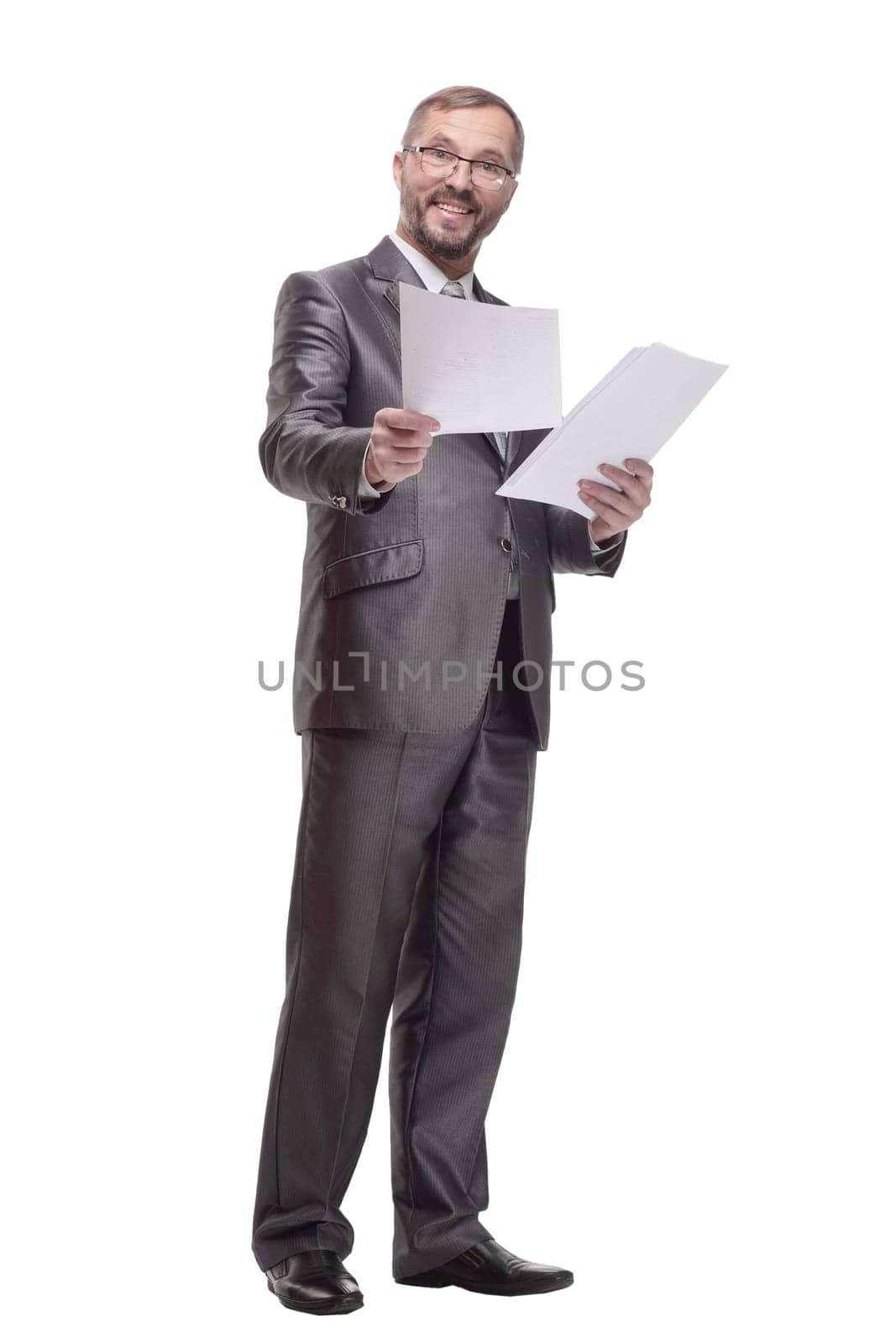 in full growth.Executive business man with documents. isolated on a white background.