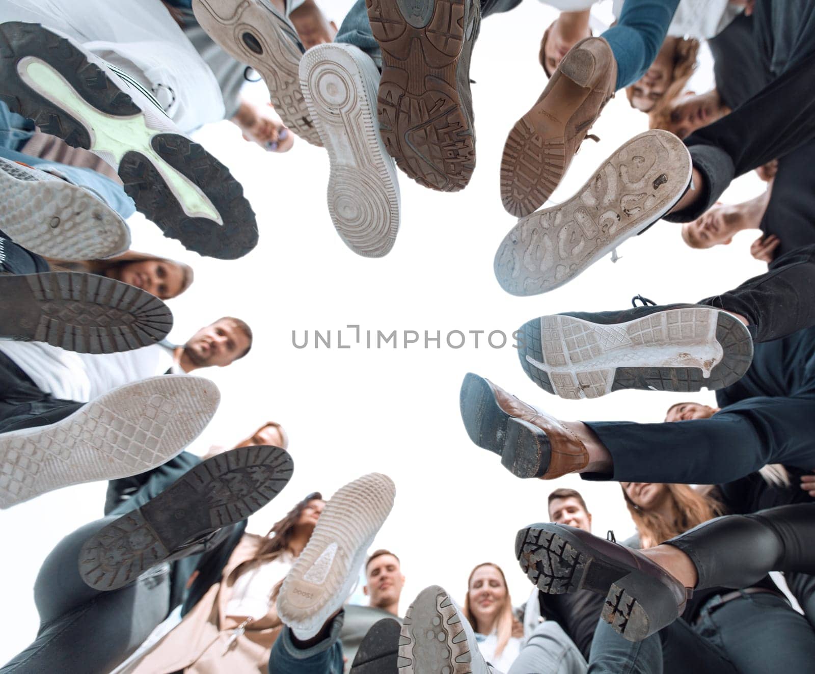 bottom view. cheerful young people standing in a circle by asdf