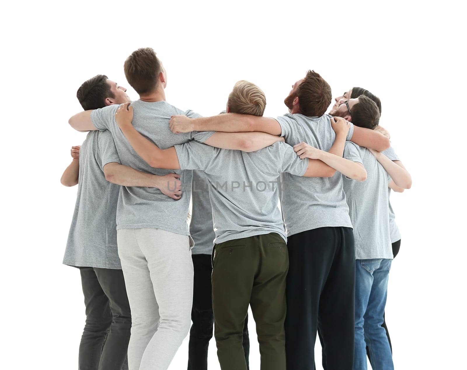 in full growth. a group of young people standing in a circle and looking up . isolated on white