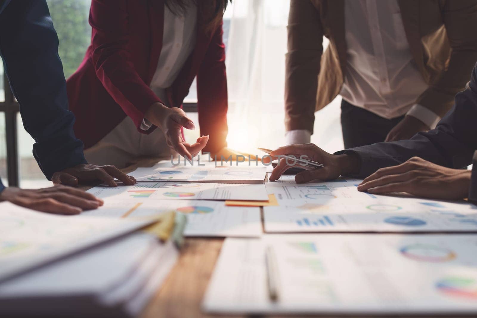 Close up of Diverse colleagues gather brainstorm discuss financial statistics at office meeting. finance, teamwork, Big data Graphs Charts concept.