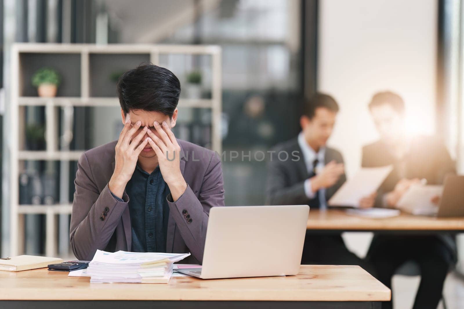 Stressed business person working and research strategy on laptop and looking worried, tired, finance, teamwork, Big data Graphs Charts concept by itchaznong