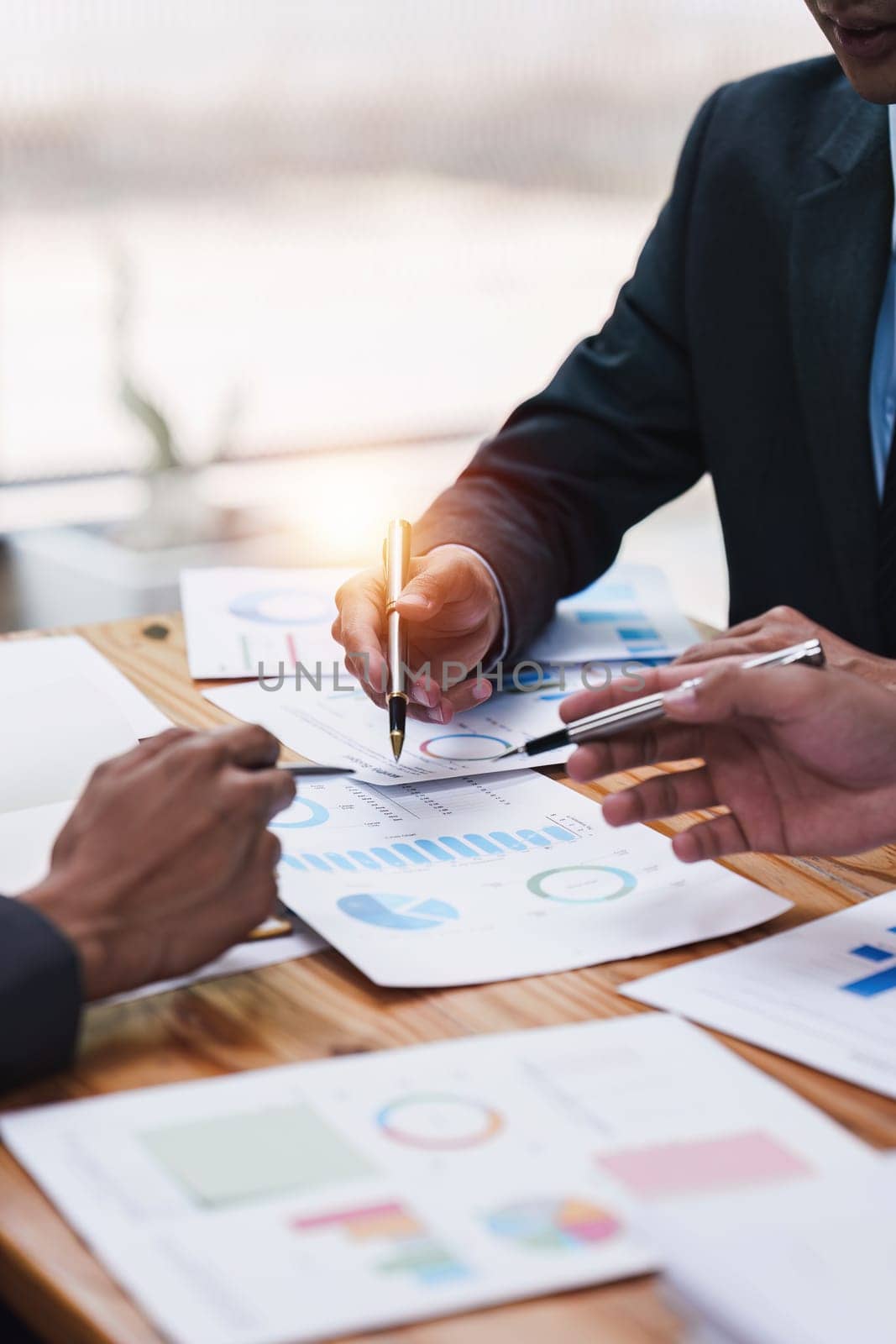 Close up of Diverse colleagues gather brainstorm discuss financial statistics at office meeting. finance, teamwork, Big data Graphs Charts concept.