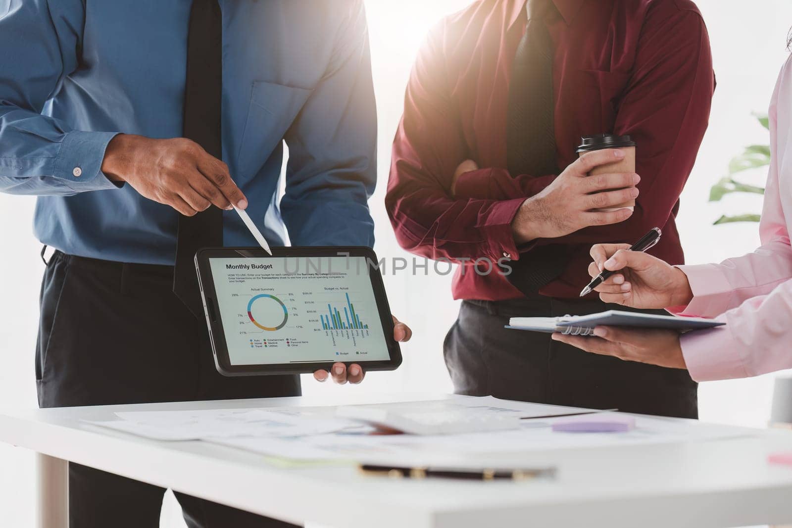 Close up of Diverse colleagues gather brainstorm discuss financial statistics at office meeting. finance, teamwork, Big data Graphs Charts concept.