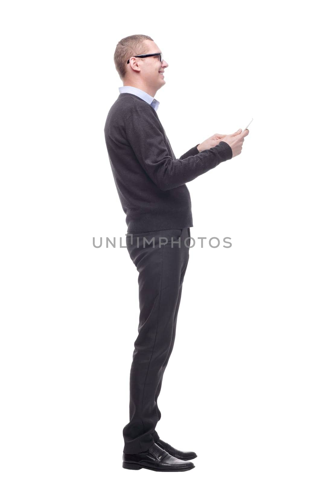 Side view of smiling business man using his tablet computer against a white background