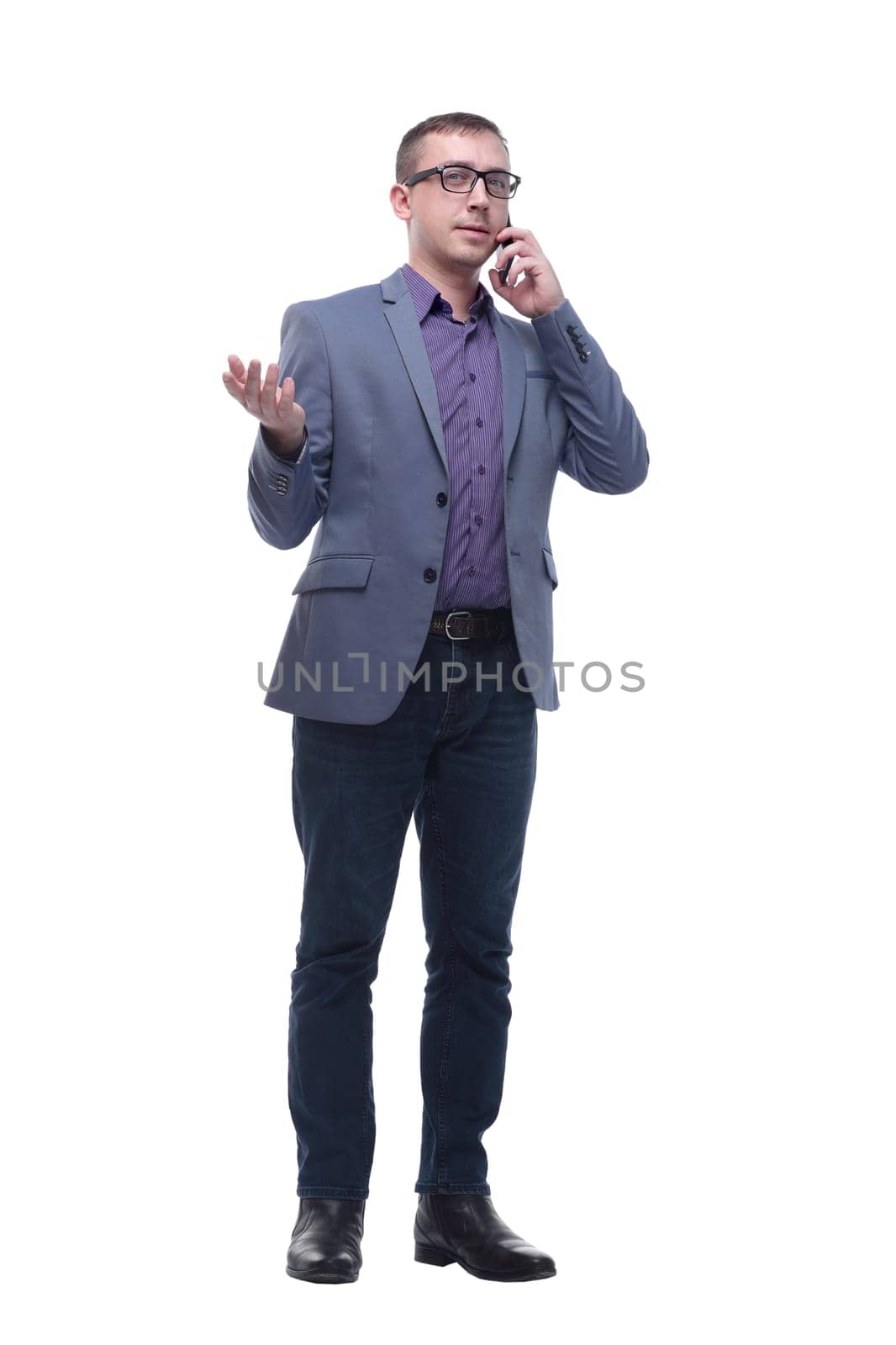 Full-length portrait of a happy businessman talking on the phone over white background