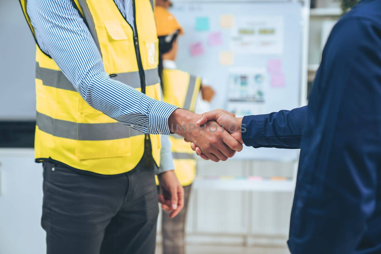 After concluding the meeting, competent investor shakes hands with engineer. Concept of the agreement between engineers and investors.