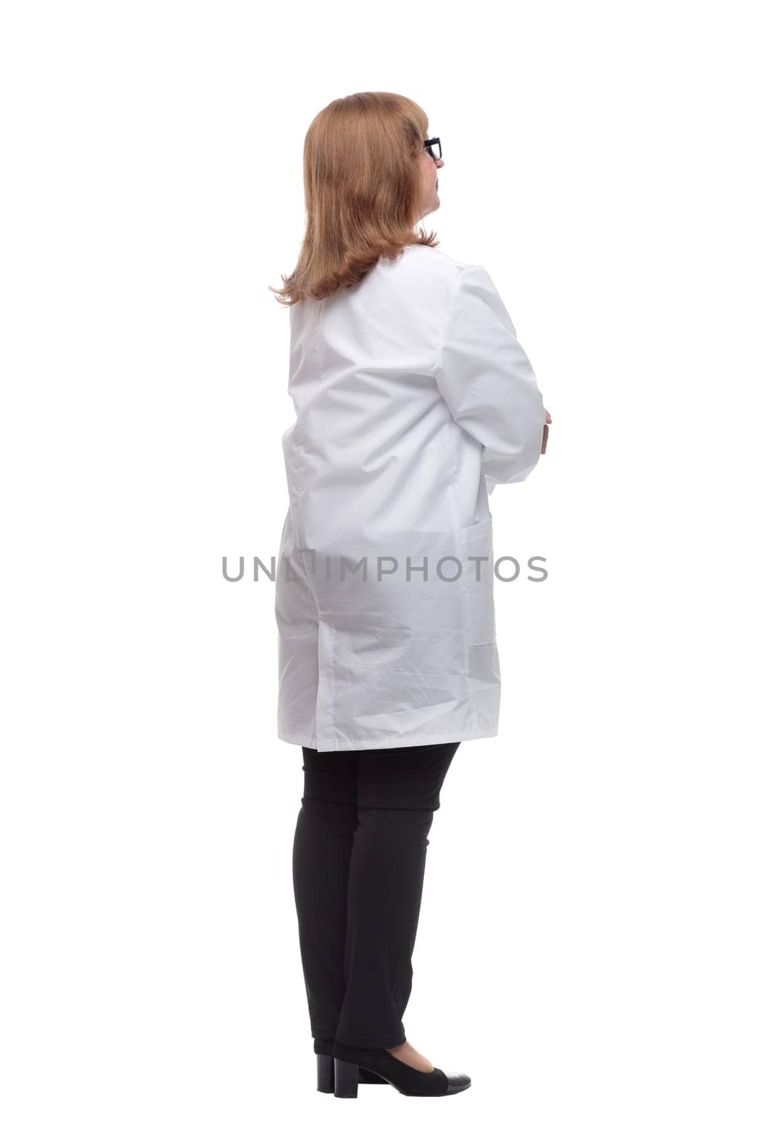 side view. serious female medic looking at a white screen. isolated on a white background