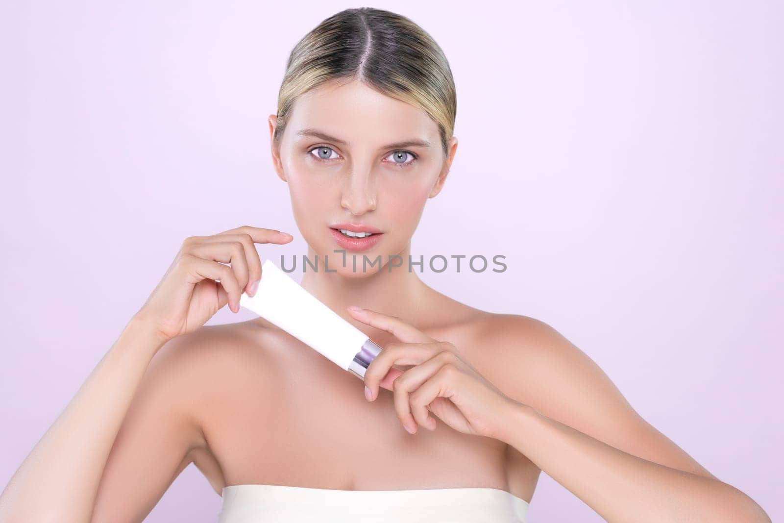 Alluring portrait of perfect skin woman holding mockup moisturizer tube. by biancoblue