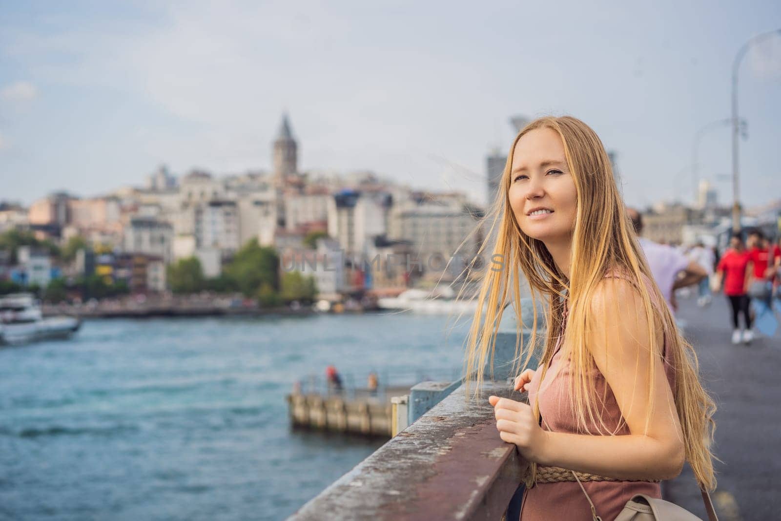 Portrait of beautiful woman tourist with view of Galata tower in Beyoglu, Istanbul, Turkey. Turkiye.