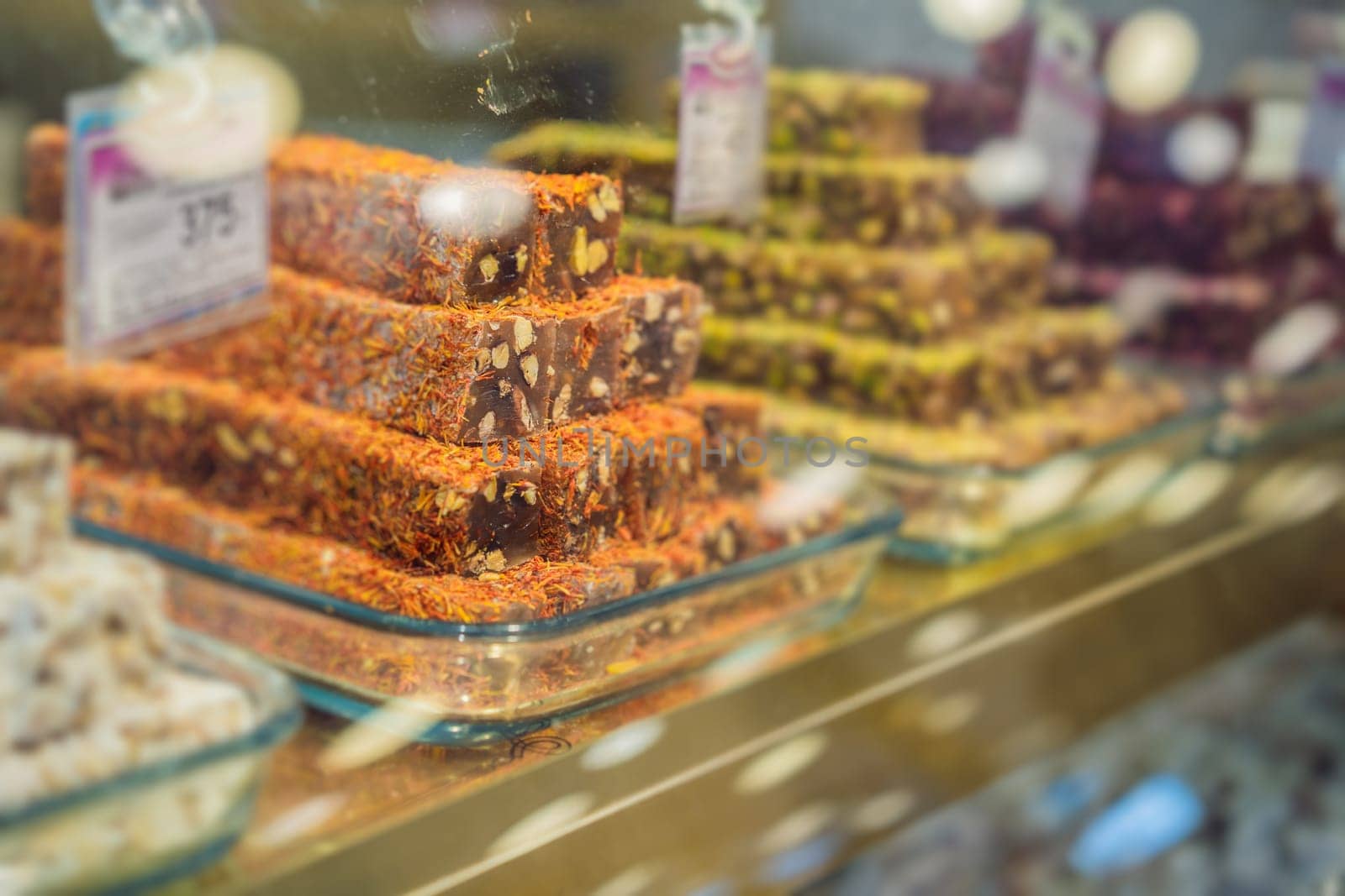 Traditional oriental sweet pastry cookies, nuts, dried fruits, pastilles, marmalade, Turkish desert with sugar, honey and pistachio, in display at a street food market by galitskaya