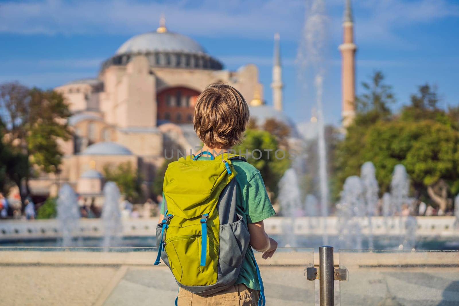 Boy Tourist enjoy beautiful view on Hagia Sophia Cathedral, famous islamic Landmark mosque, Travel to Istanbul, Turkey. Traveling with kids concept. Sunny day architecture and Hagia Sophia Museum, in Eminonu, istanbul, Turkey. Turkiye.