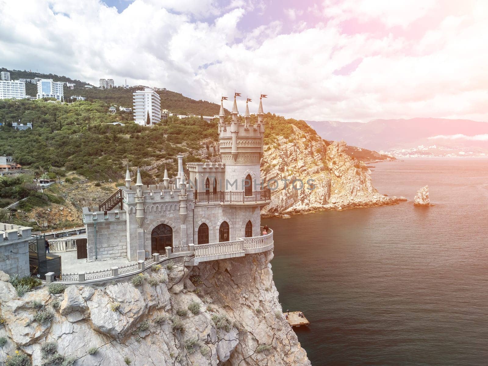 Crimea Swallow's Nest Castle on the rock over the Black Sea. It is a tourist attraction of Crimea. Amazing aerial view of the Crimea coast with the castle above abyss on sunny day. by panophotograph
