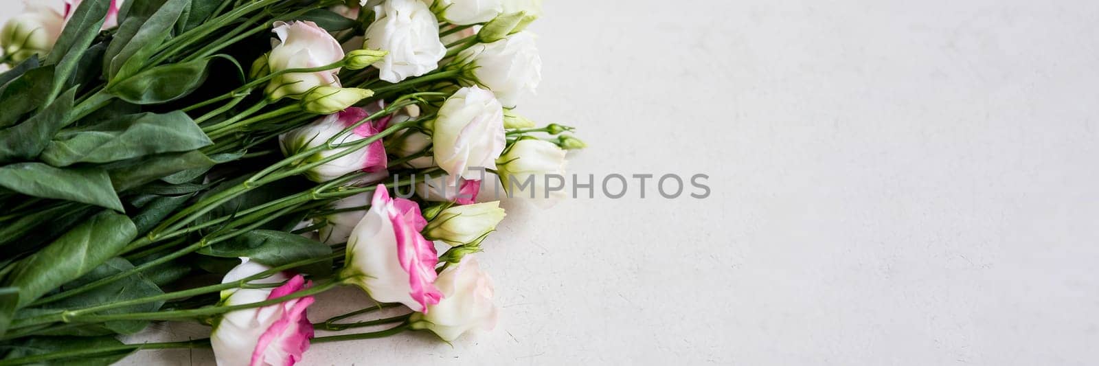 Pink carnation and white eustoma flowers composition on pink pastel background, creative flat lay, copy space. Garden flowers, spring summer blush floral design, Mother's day concept.web banner by YuliaYaspe1979