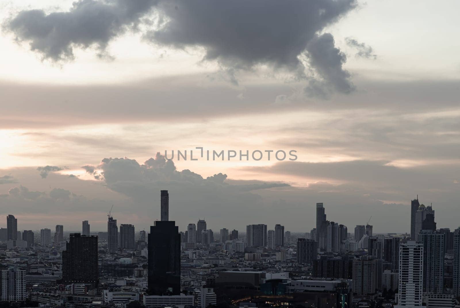 Bangkok, Thailand - Aug 14, 2022 - Gorgeous scenic of the sunset with cloud on the sky over large metropolitan city in Bangkok. Nice city view, Space for text, No focus, specifically.