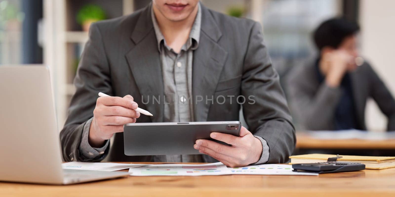 Accountant man working on digital tablet and do document, tax, exchange, research, accounting and Financial advisor concept.