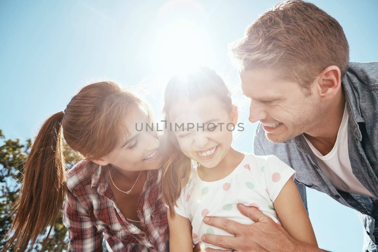 Enjoying some bright moments. a family bonding together outdoors. by YuriArcurs