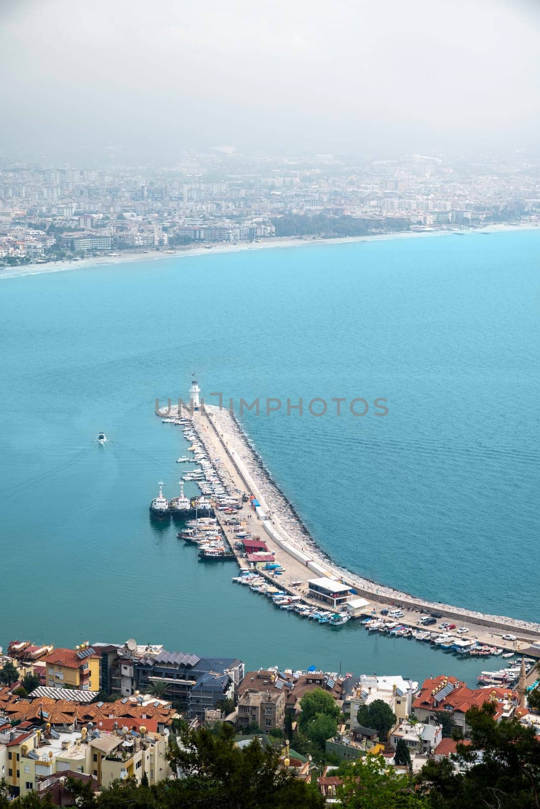 Aerial view of Alanya marina and city on a cloudy day by Sonat