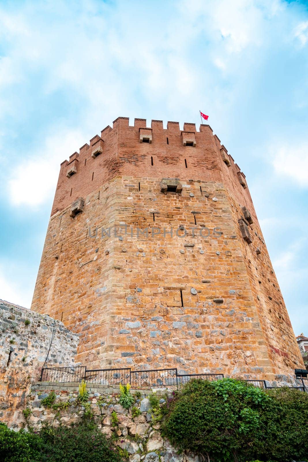 Ancient red tower in Alanya Turkey on a sunny day by Sonat