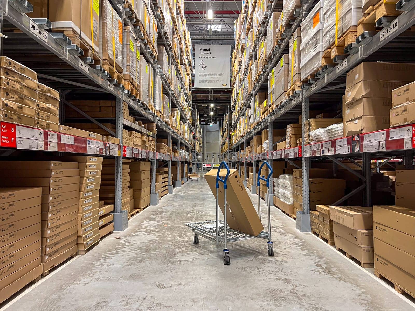 Antalya, Turkey - April 1, 2023: A cart in warehouse aisle in an IKEA store by Sonat