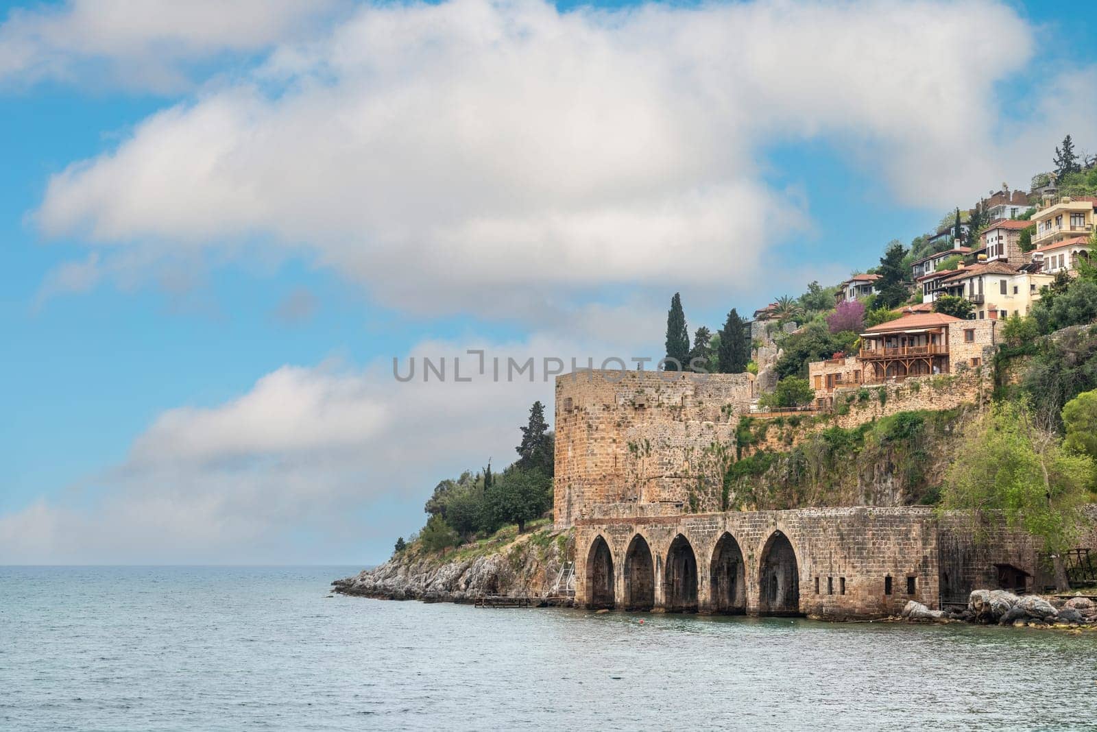 Ancient shipyard near Alanya Red Tower on a sunny day by Sonat