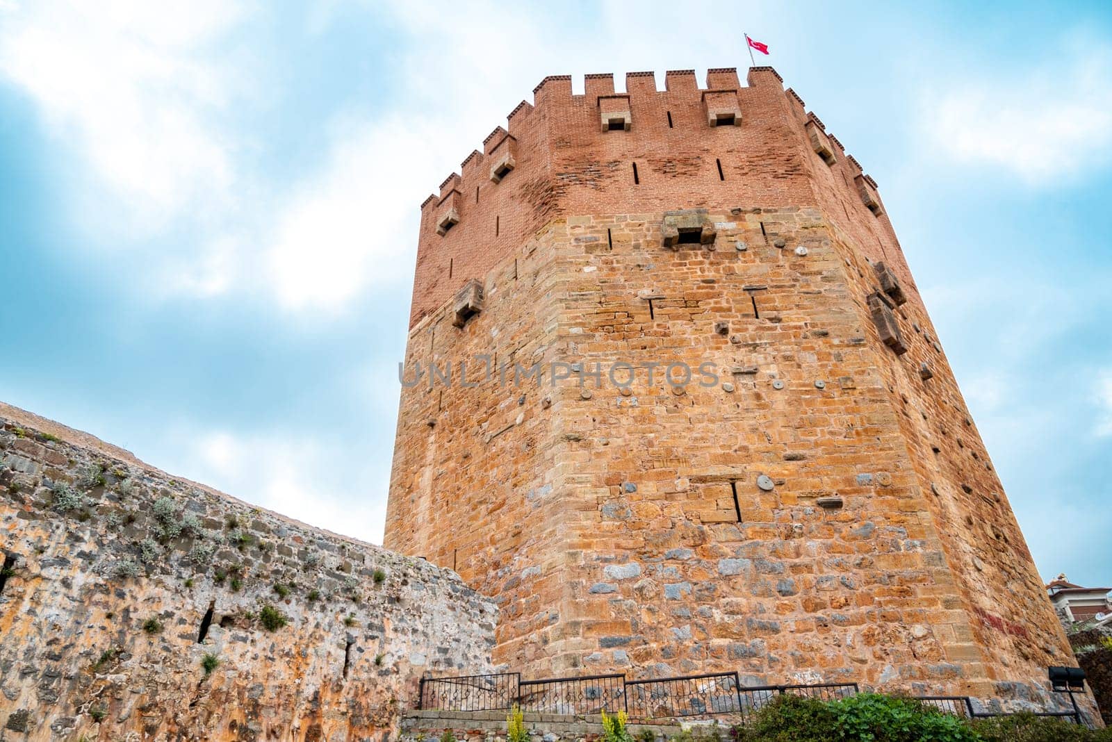 Ancient red tower in Alanya Turkey on a sunny day by Sonat