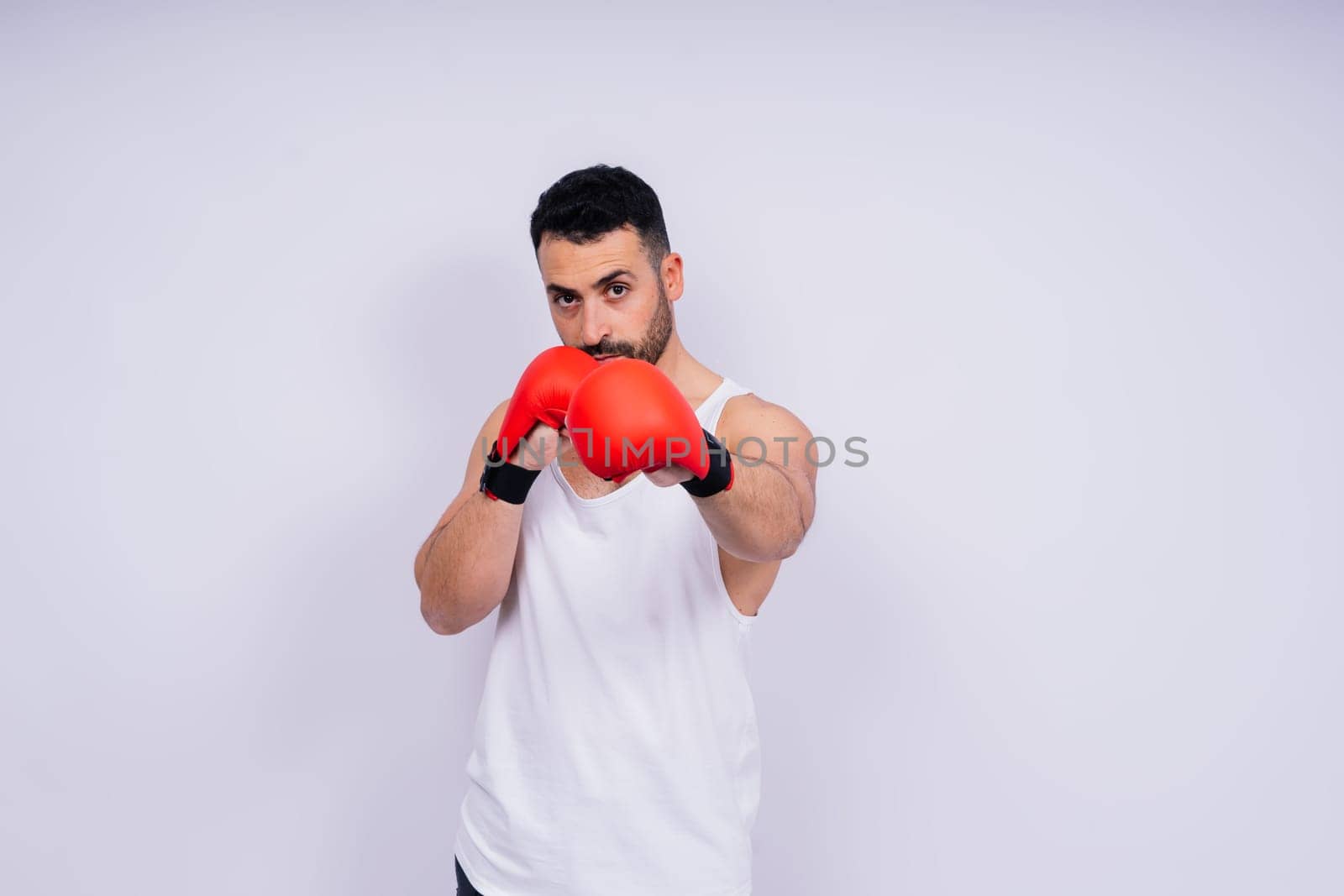 Young caucasian handsome man isolated on white background with boxing gloves by Zelenin