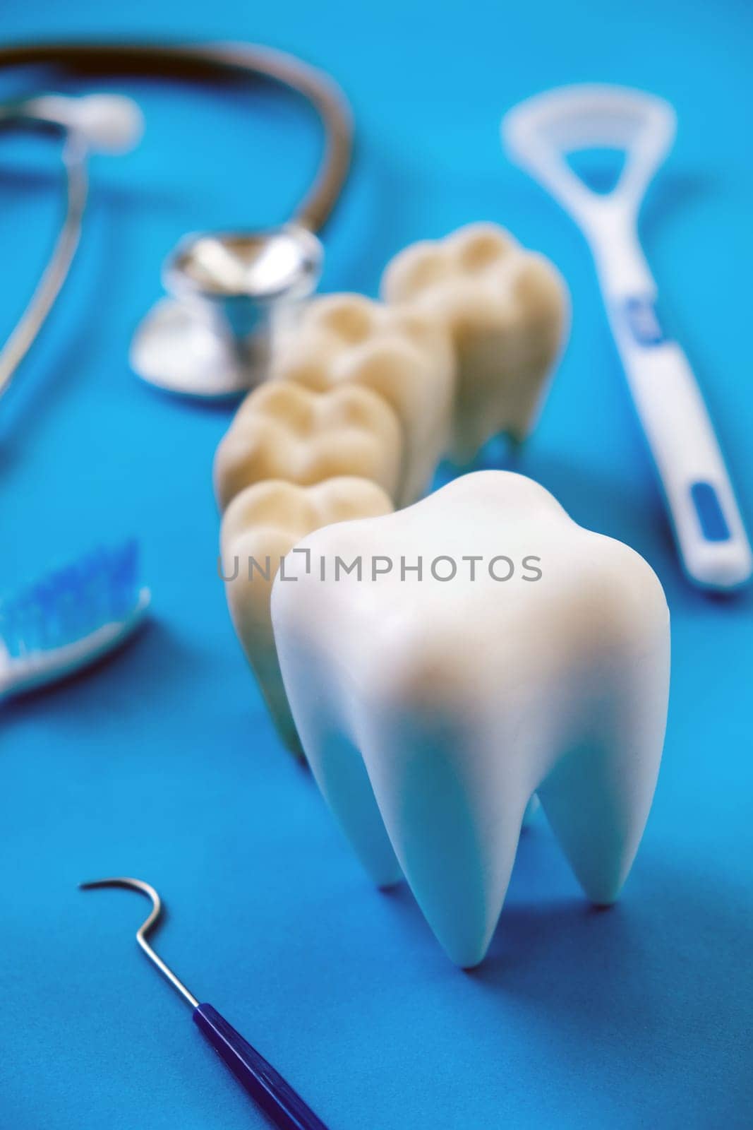 Dental model and dental equipment on blue background, Dentistry concept.