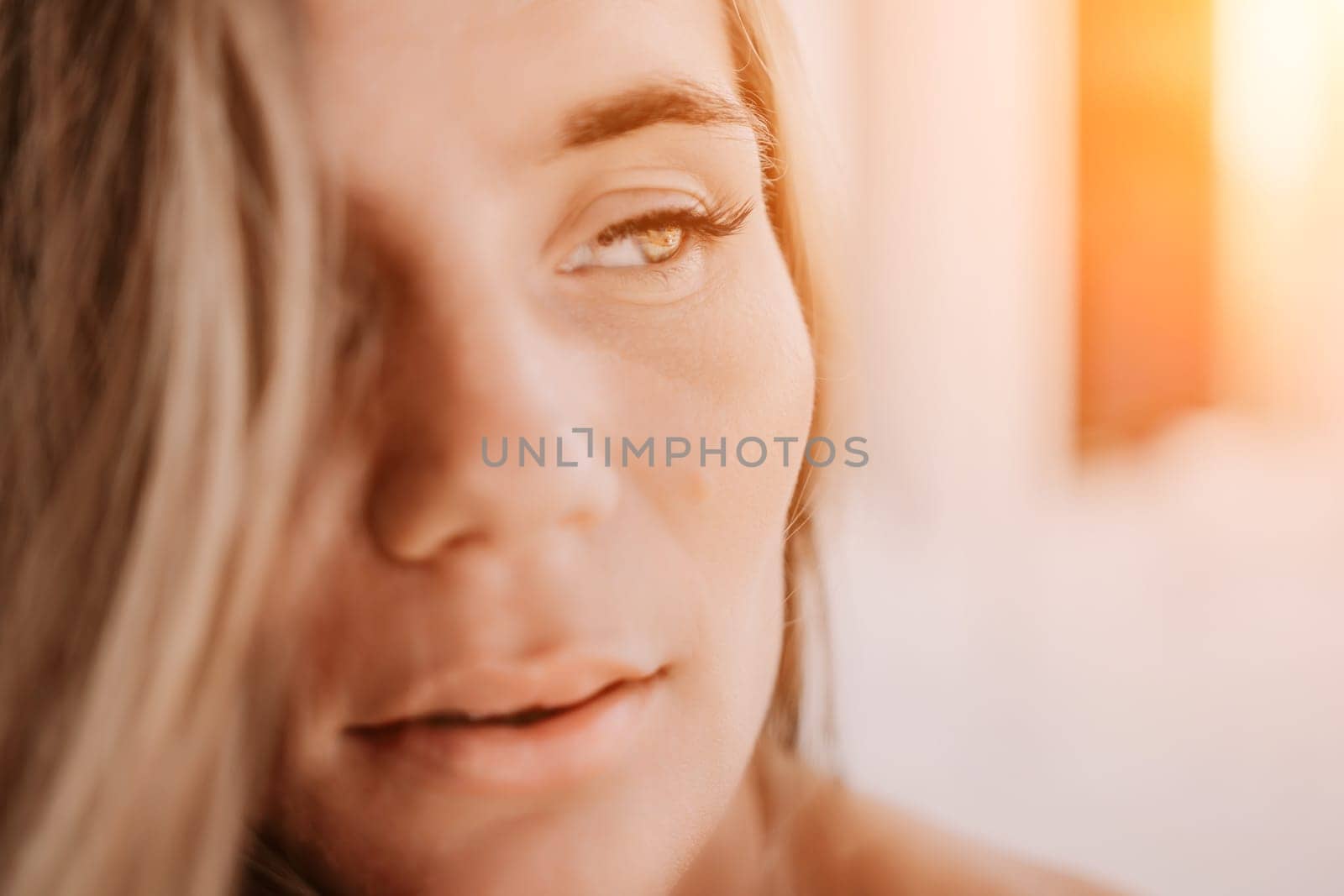 Happy woman portrait in cafe. Boho chic fashion style. Outdoor photo of young happy woman with long hair, sunny weather outdoors sitting in modern cafe. by panophotograph