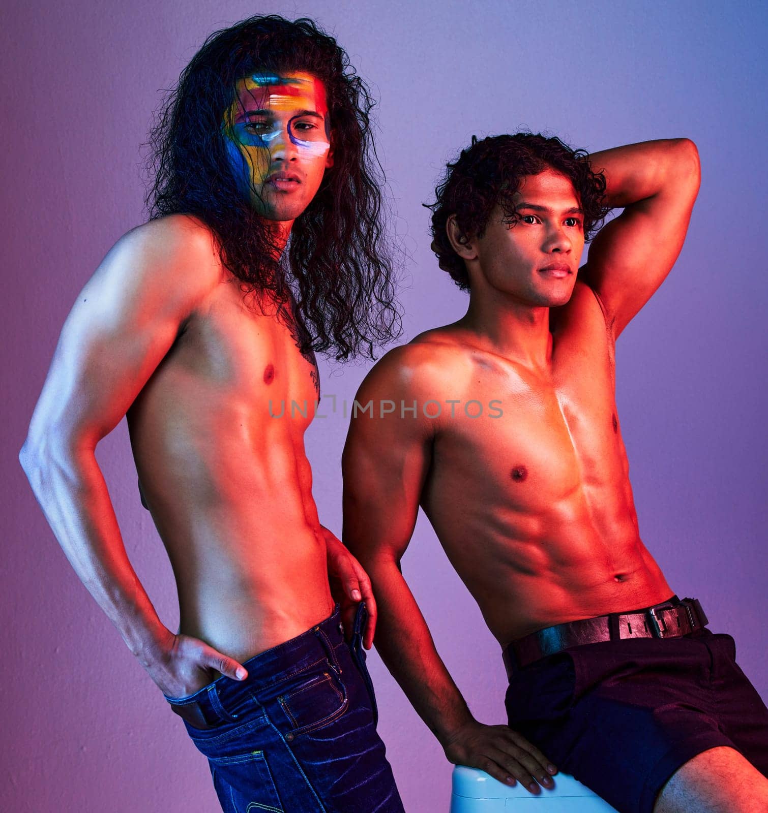 Creative, body and men models in neon background for creativity with paint as artwork isolated on a purple studio backdrop. Colorful, muscle and artistic people for skin, beauty or fashion pose by YuriArcurs