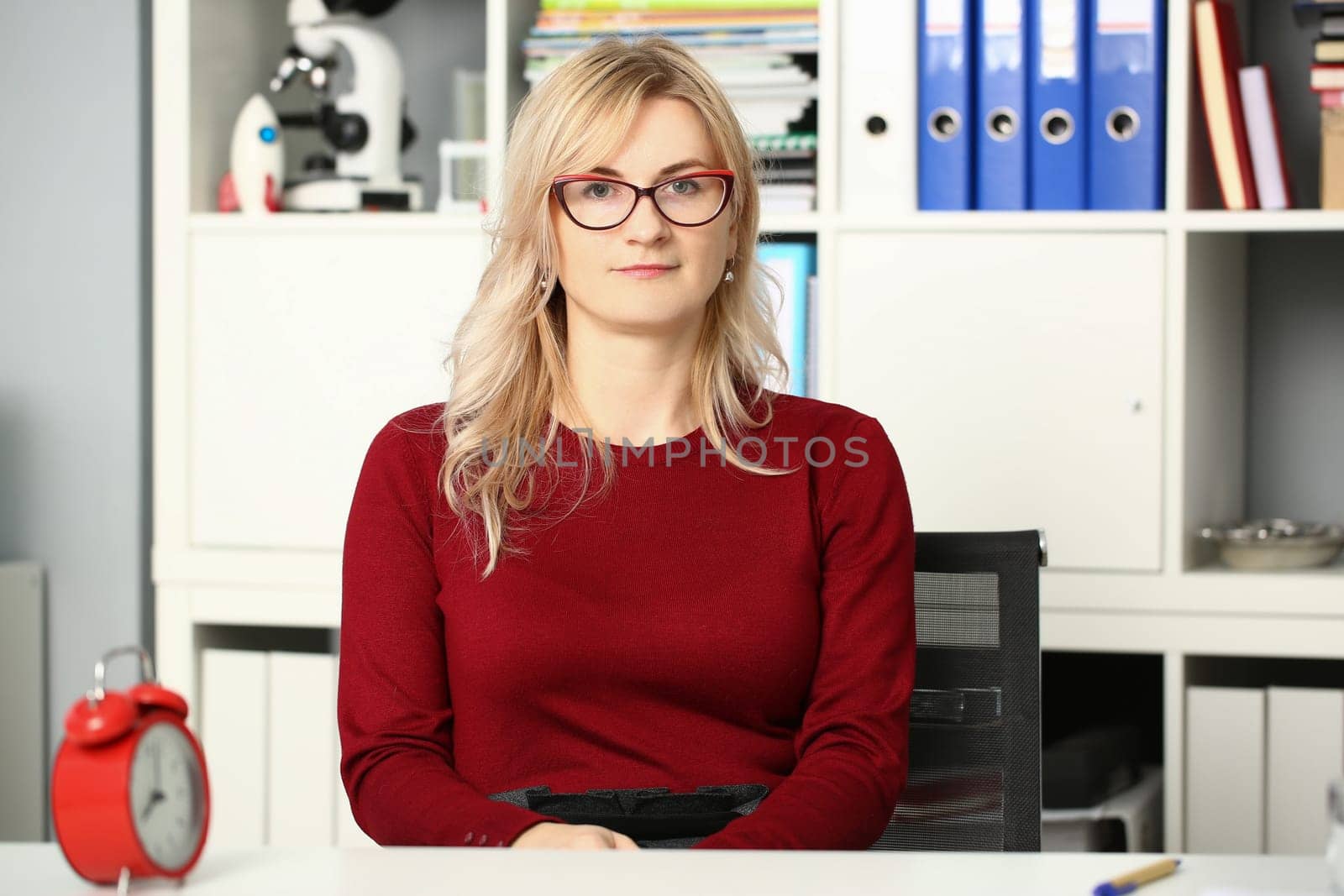Portrait of businesswoman in glasses at workplace in office. Business consultant secretary or manager