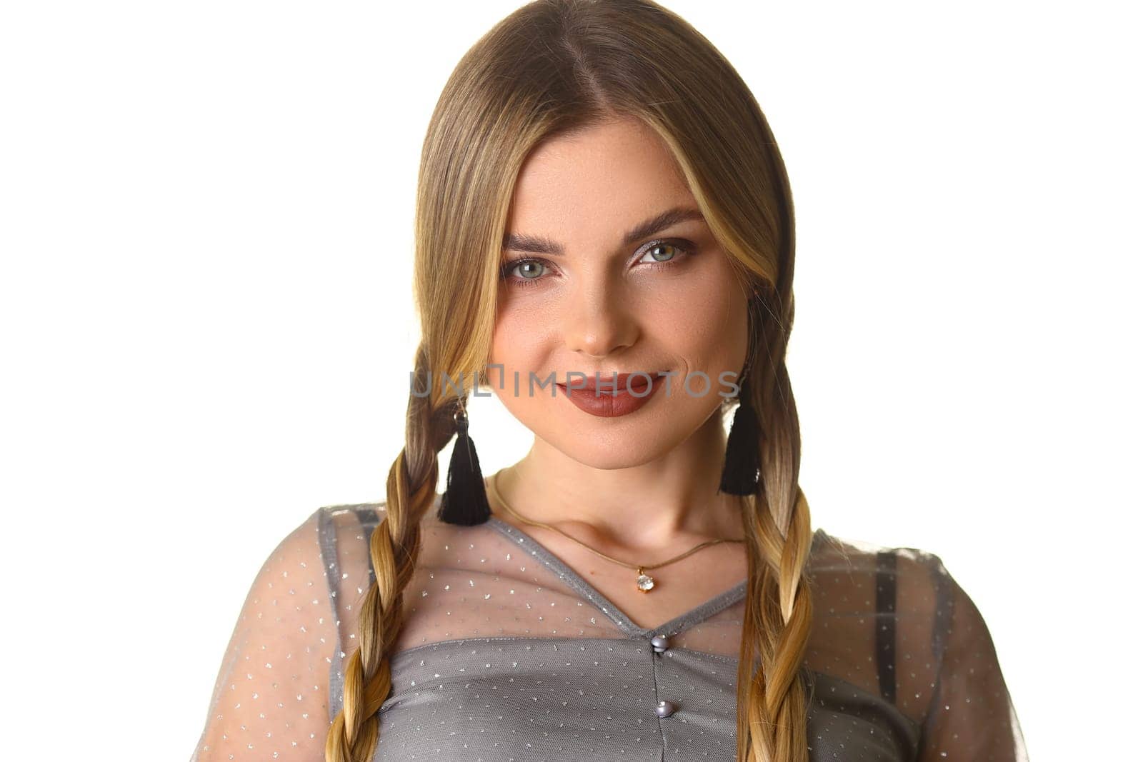 Portrait of beautiful woman with evening makeup and pigtails. Cute young woman with beauty makeup