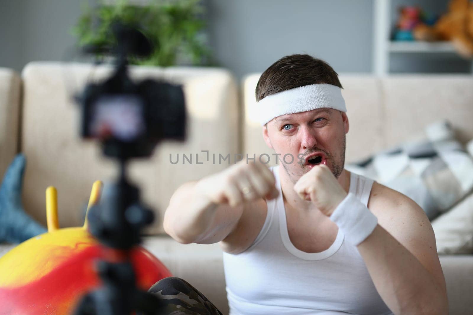 Confident man looking at the camera and clenching fist encouraging you to play sports. Remote fitness motivation and humor. Yes you can do it and believe in yourself