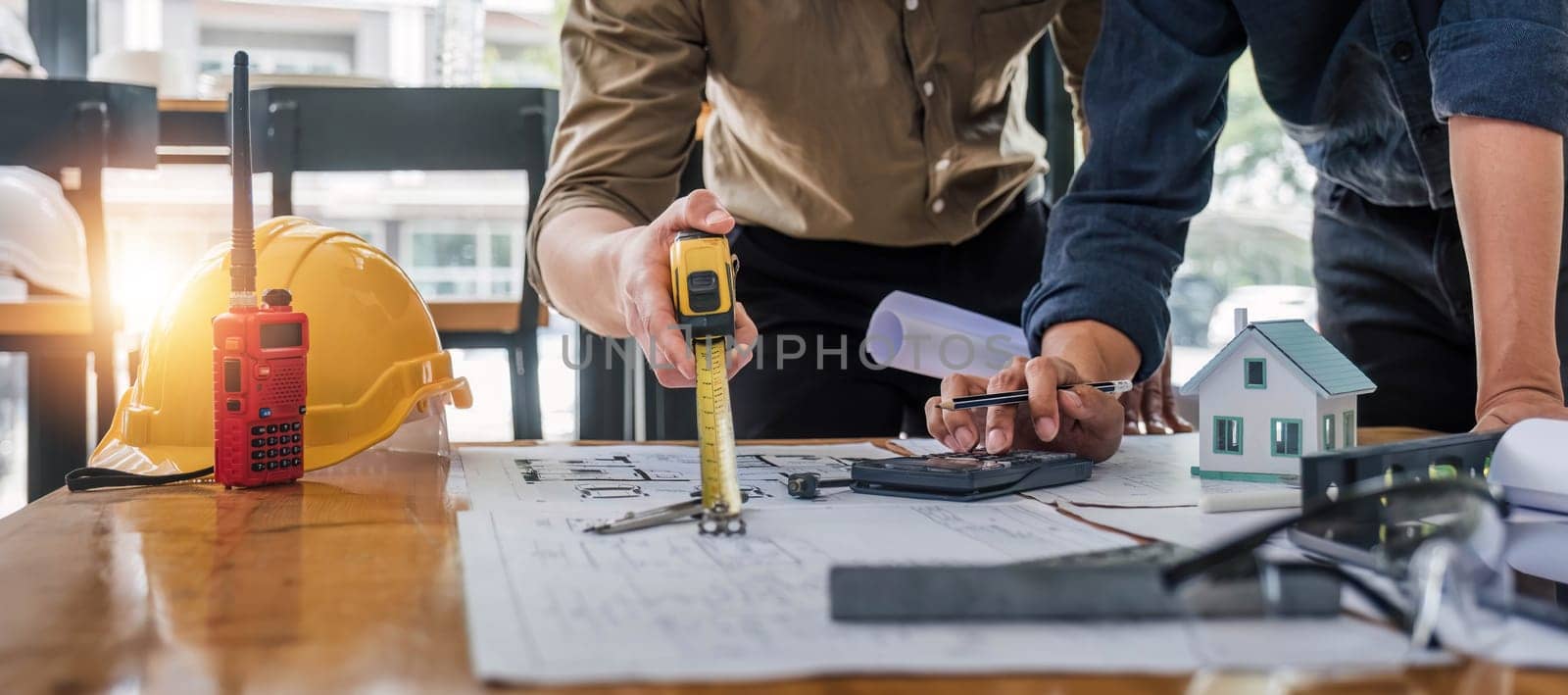 Civil engineer teams meeting working together wear worker helmets hardhat on construction site in modern city. Foreman industry project manager engineer teamwork. Asian industry professional team. by wichayada