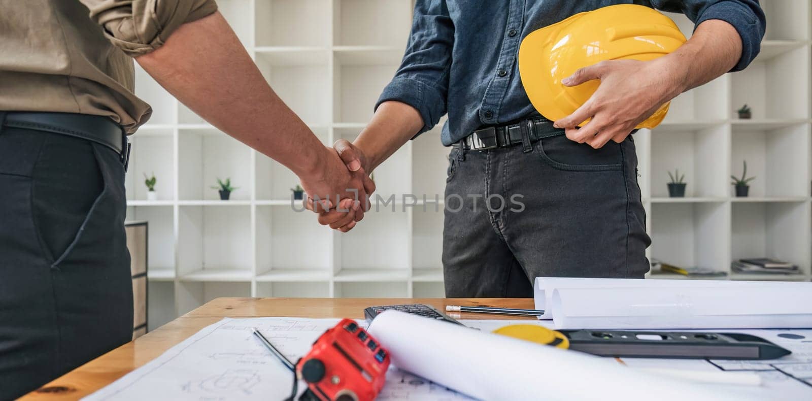 Hand in hand between project contractors and customers due to negotiation of expenses and investments, construction and repair of residential buildings.. by wichayada