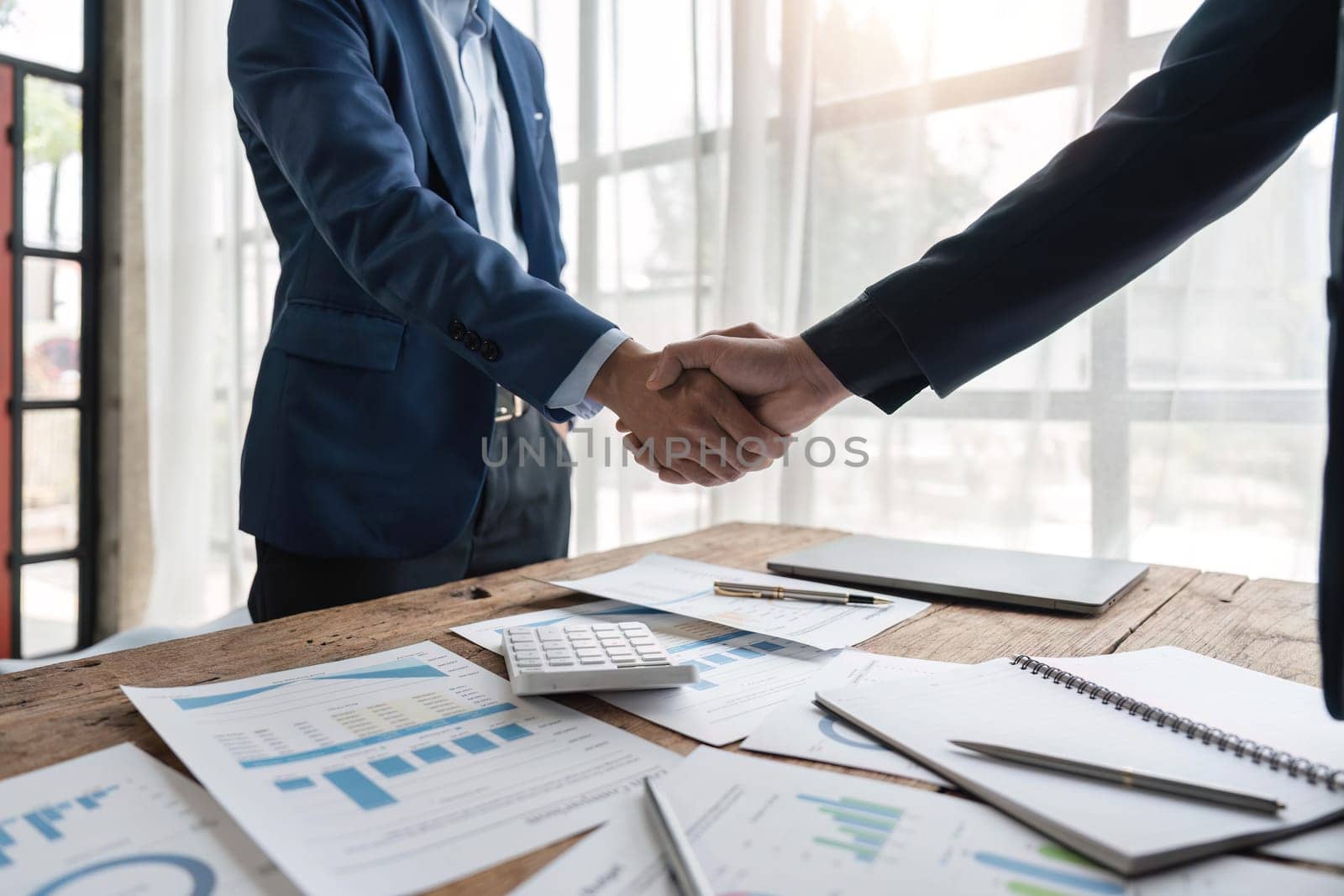 Business partnership meeting concept. Image businessmans handshake. Successful businessmen handshaking after make a deal by nateemee
