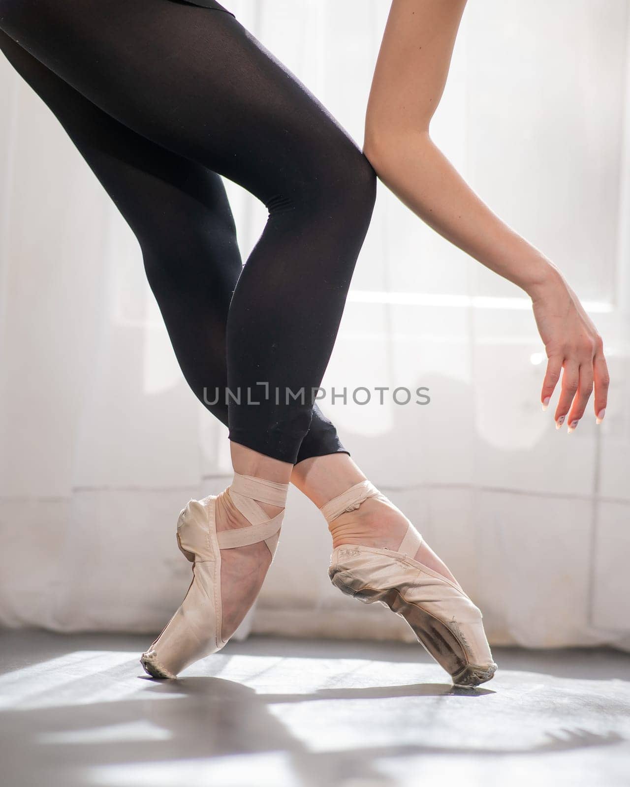 Close-up of the legs and arms of a ballerina