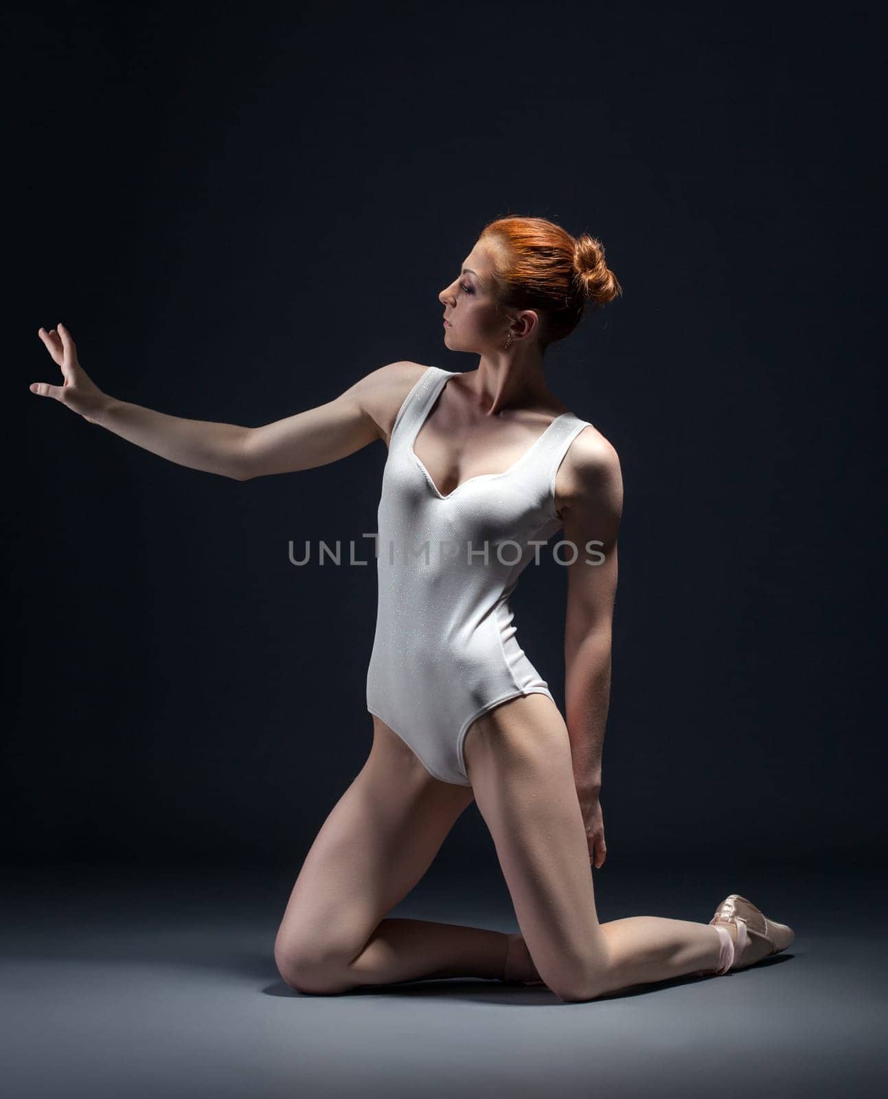 Image of skinny young ballerina posing in studio, close-up