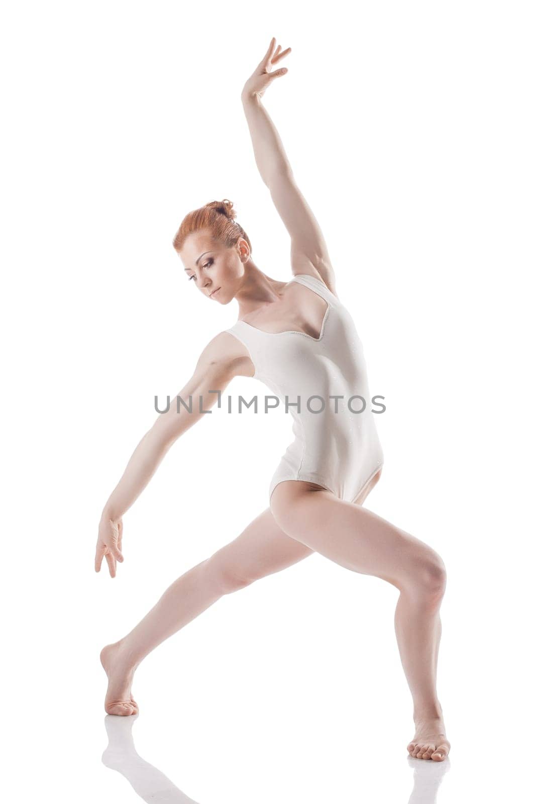 Image of elegant young woman dancing in studio, isolated on white