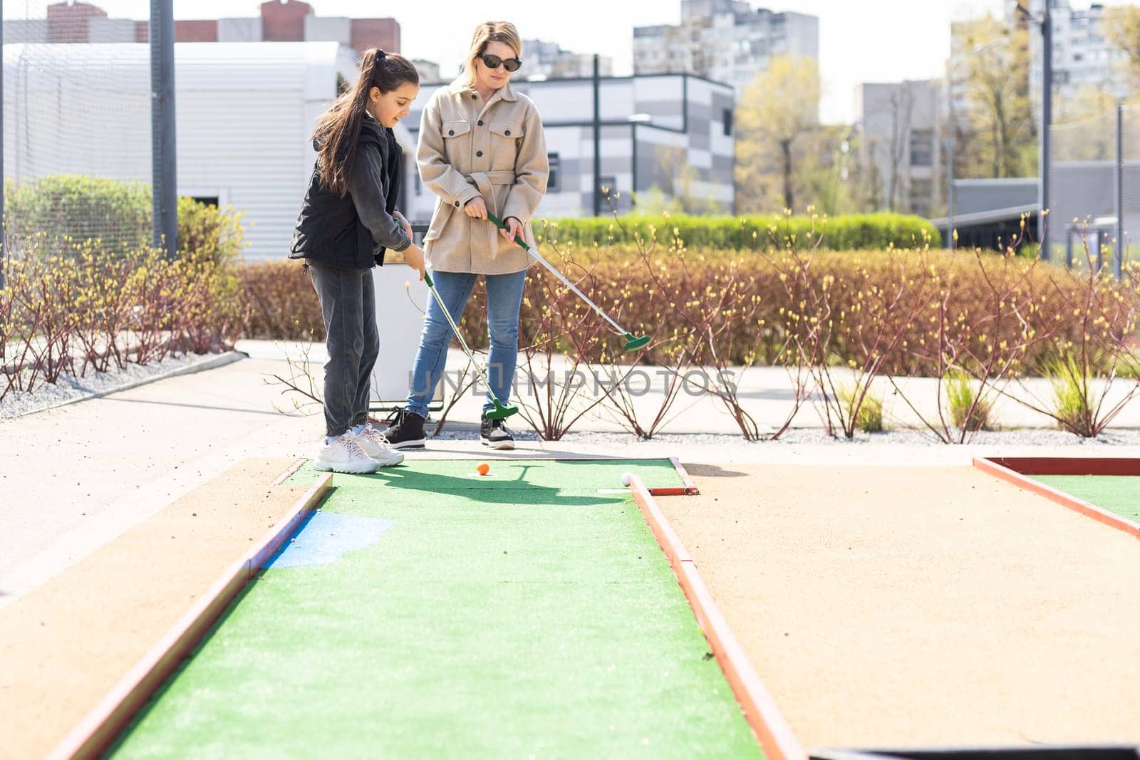 Family Time Playing Mini-Golf In The Summer.