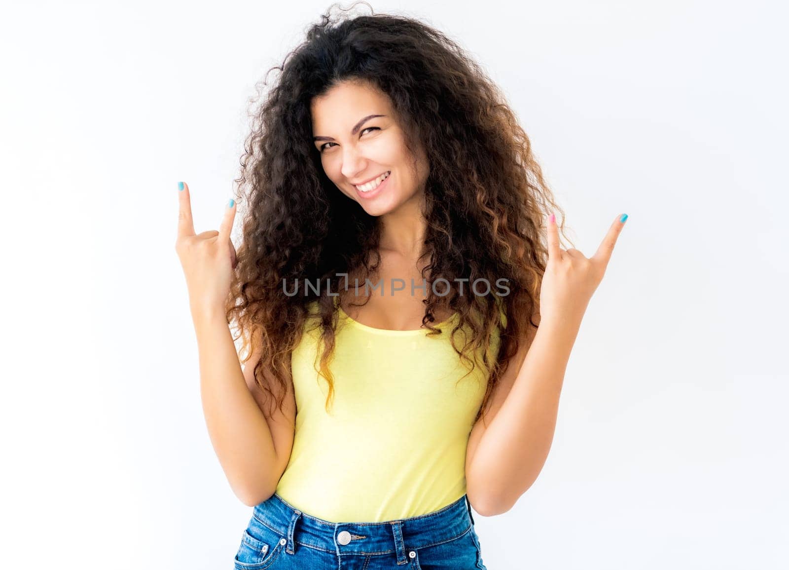 Attractive young girl showing devil horns gesture