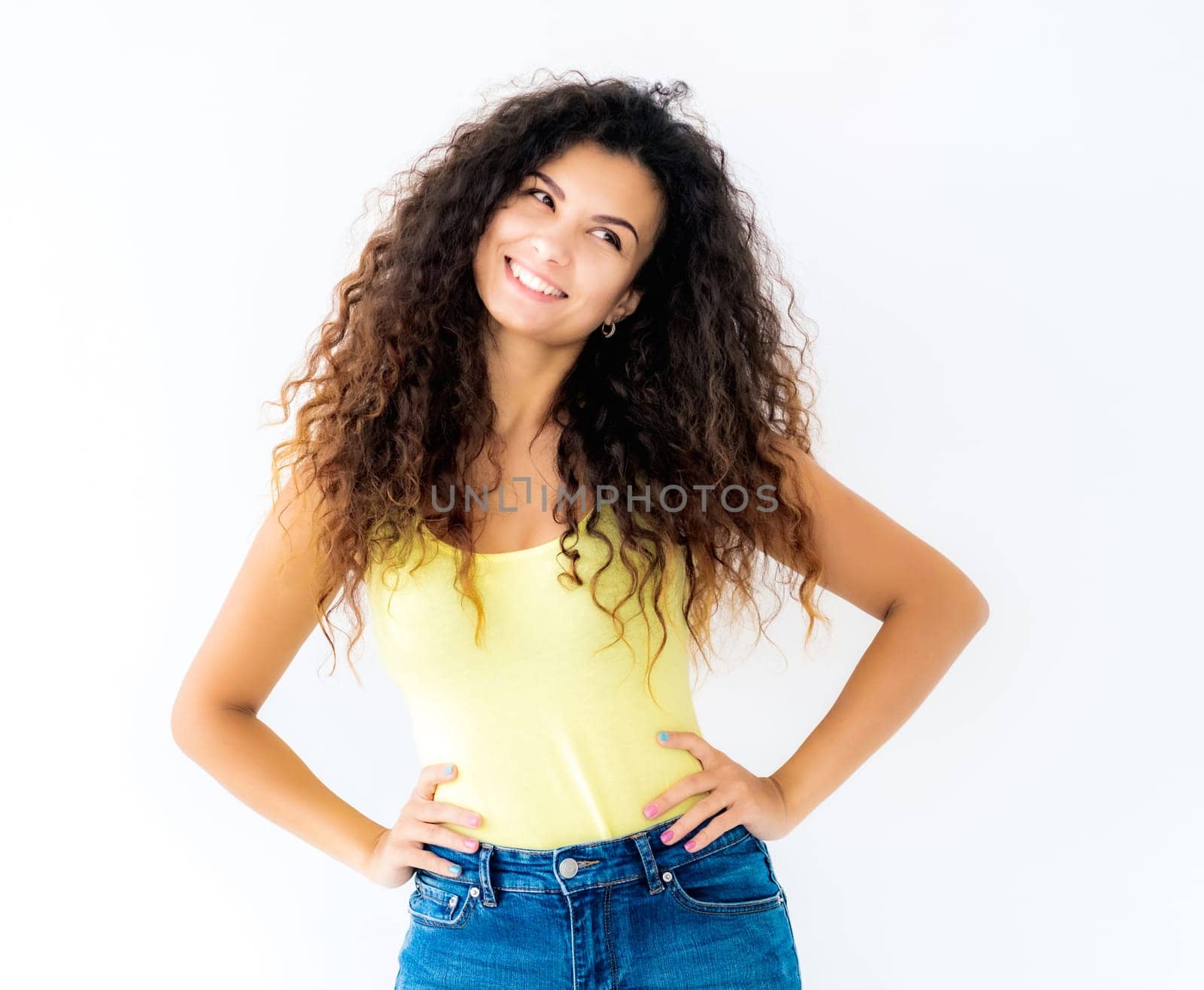 Beautiful smiling girl standing with hands on waist