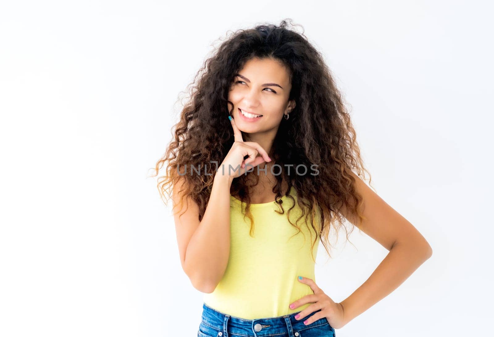 Happy young girl laughing holding hand near face